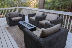 Outdoor lounge area with comfy chairs and propane fire pit